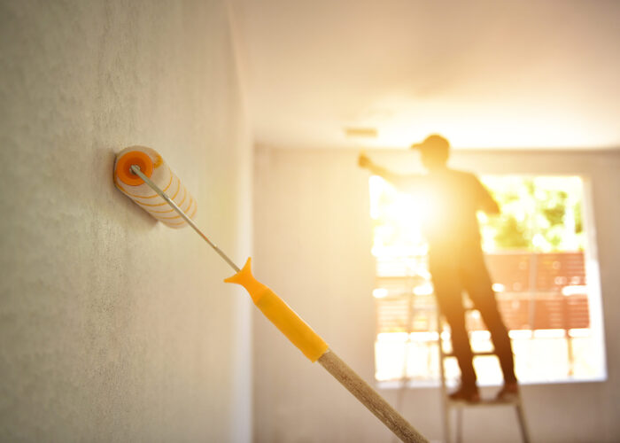 Engineer Construction painter man at work with a paint roller on the wall  In ASEAN
